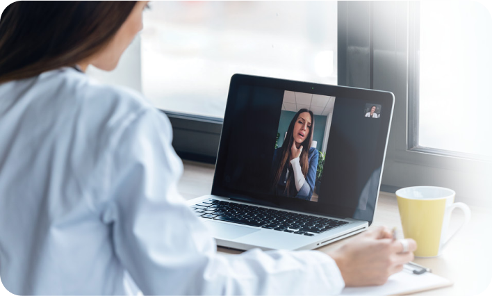 Woman in laptip looking at a webinar