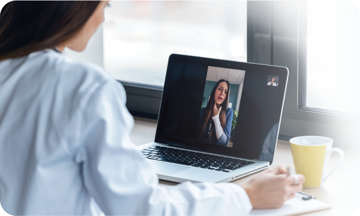 Woman in laptip looking at a webinar