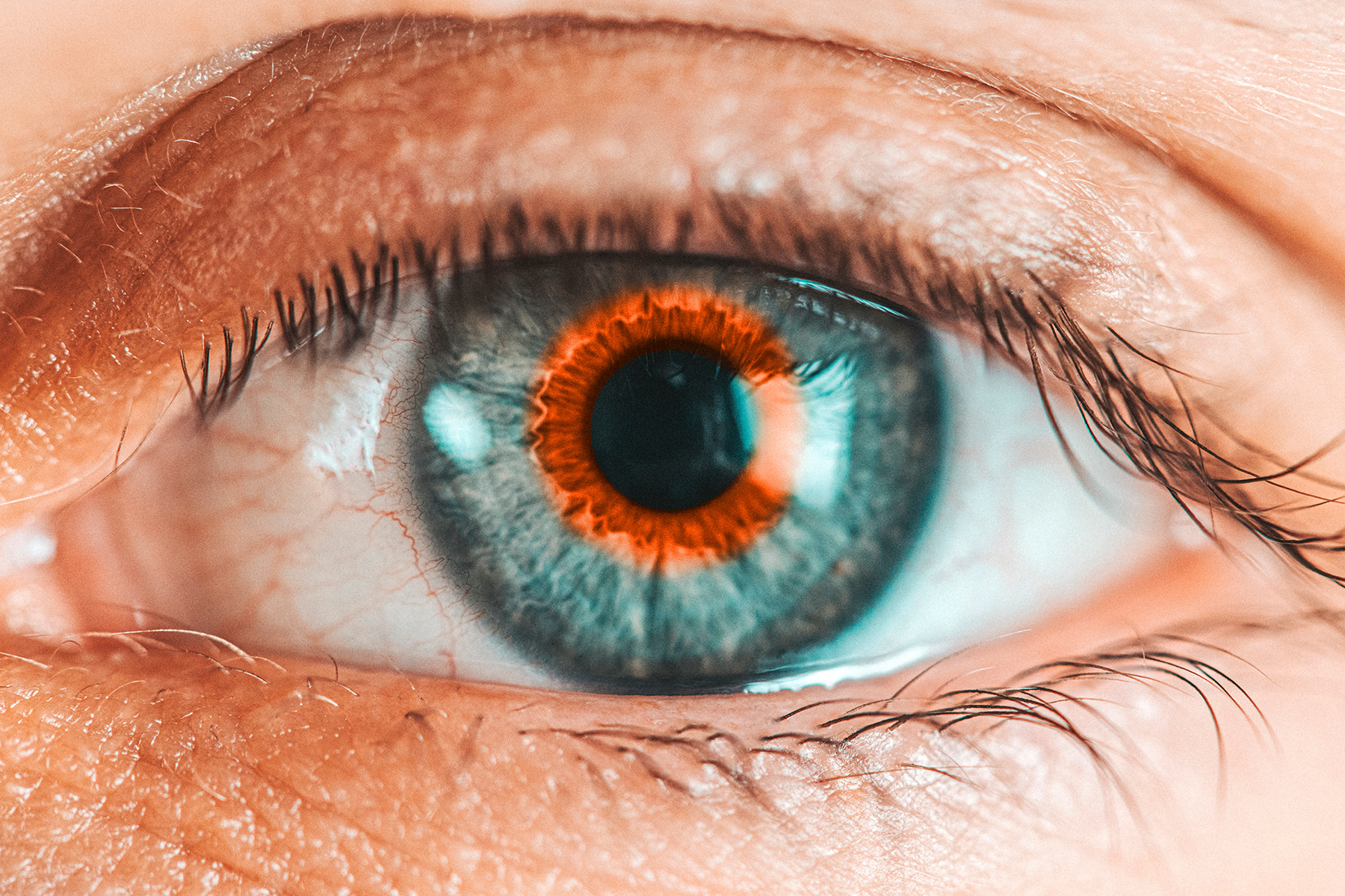 Blue eye zoomed in with orange Incentro logo