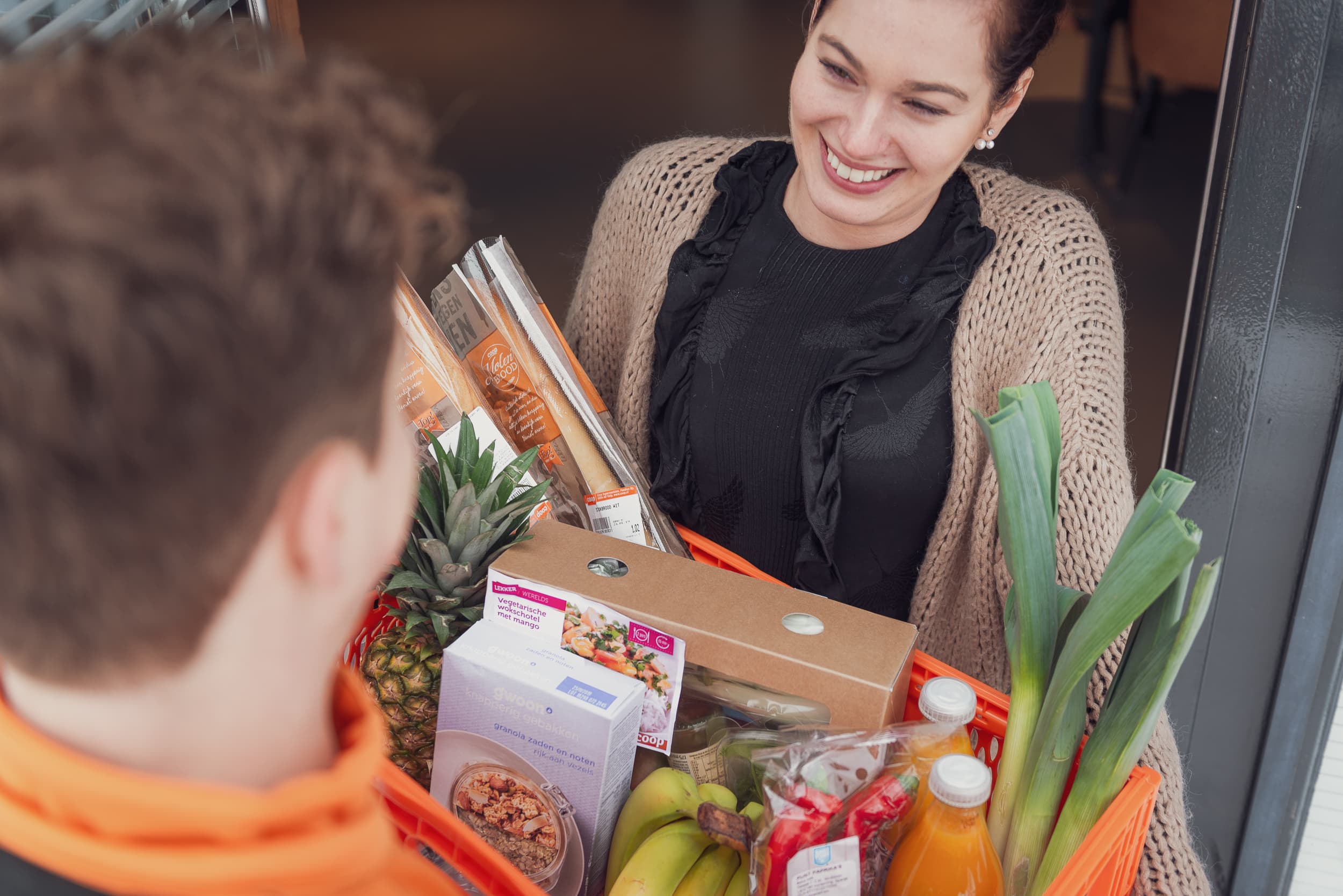 coop-omnichannel-strategy-Sarah-opening-door-to-receive-groceries-from-delivery