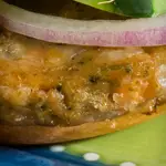 Veggie Burger Topped with Avocado, Onion, Hummus and Cheddar