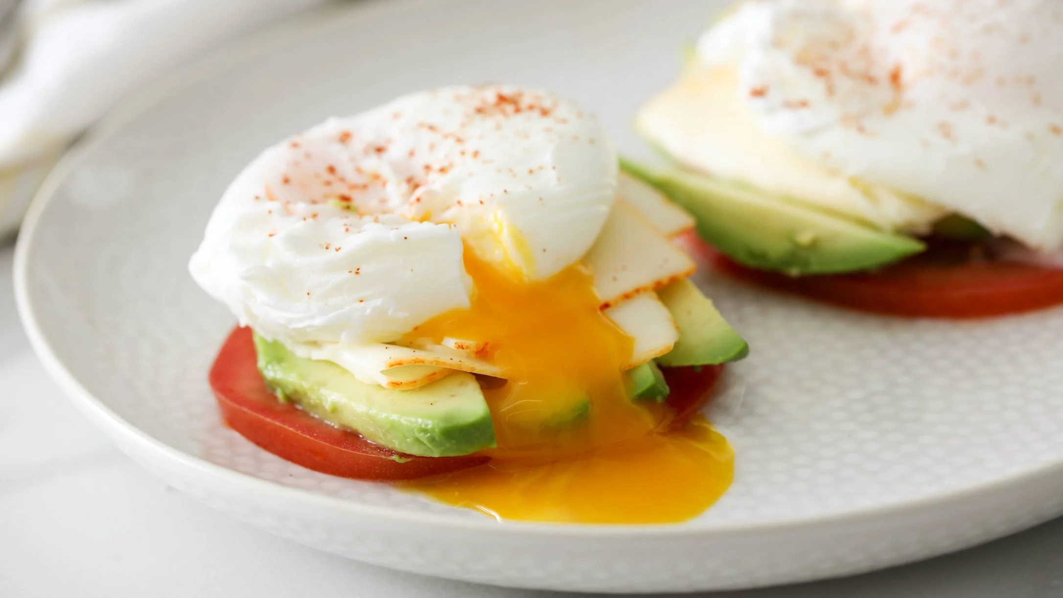 poached-eggs-over-tomato-avocado-and-muenster 1