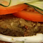Veggie Burger Topped with Tomato, Hummus and Cheddar 