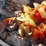 Beef Sautéed with Peppers and Onions Topped with Cheese