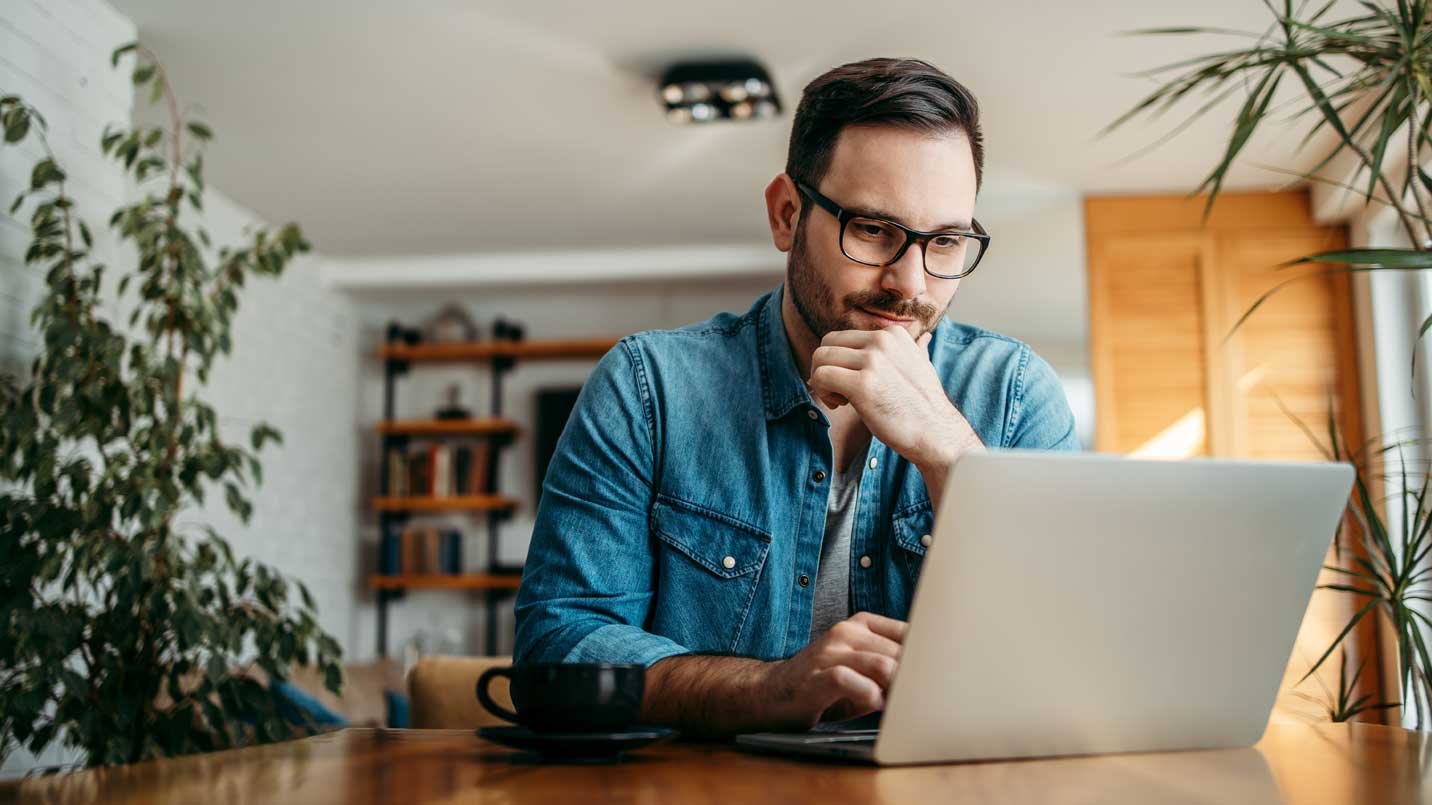 Man with glasses on computer