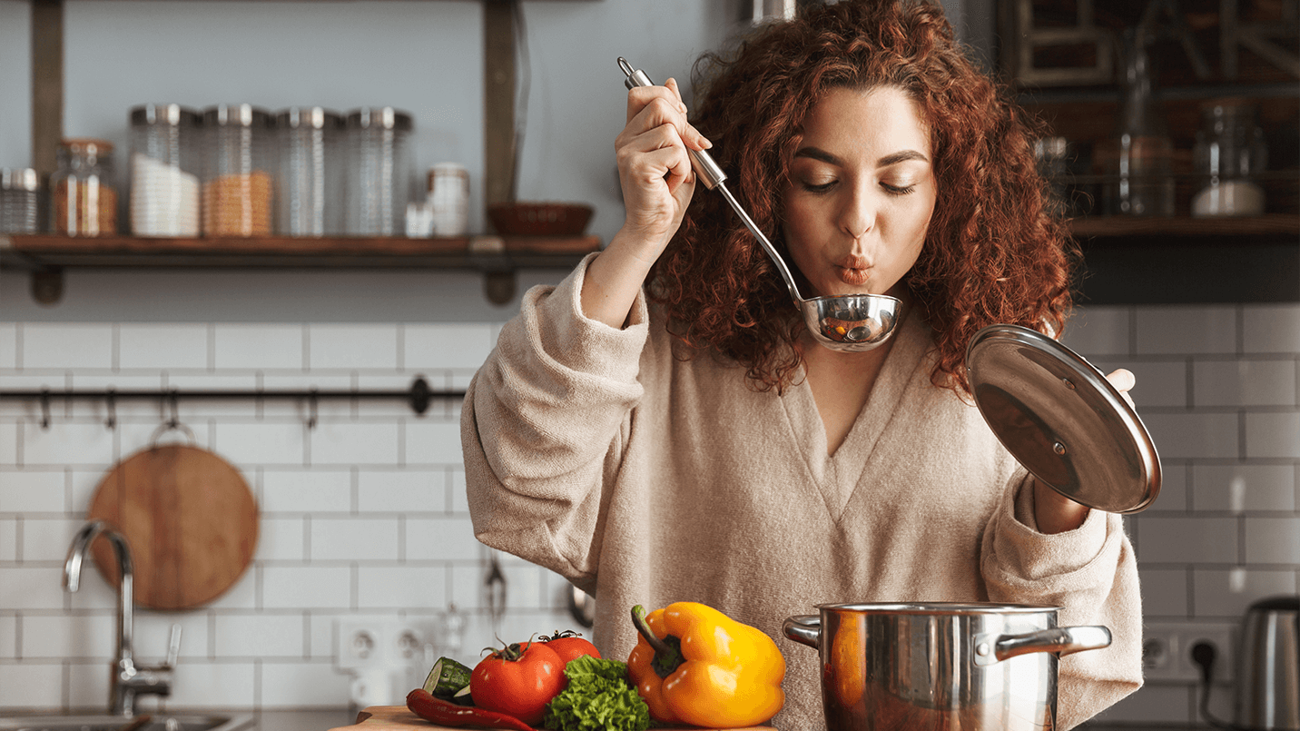 woman cooking a healthy meal in her kitchen