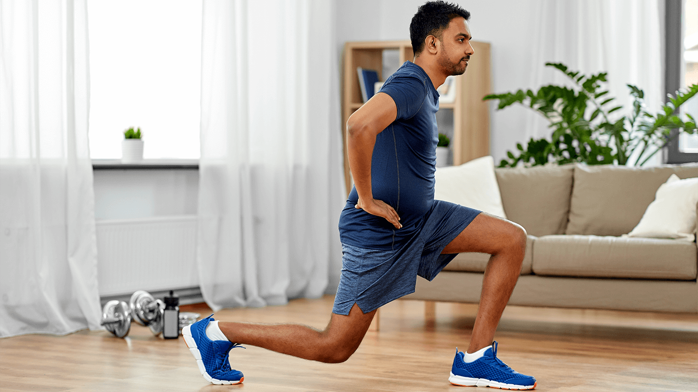 man doing lunges in his living room