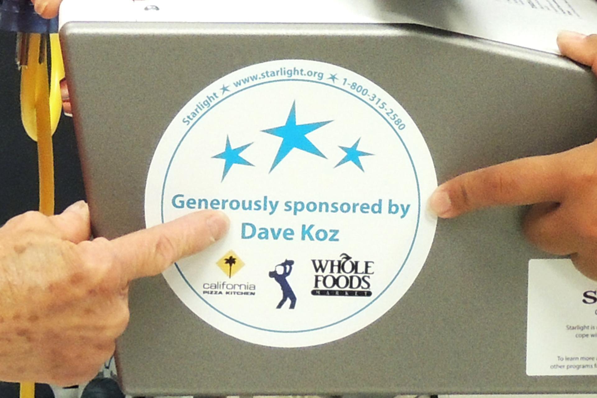 A Wii gaming station with a sticker "Generously sponsored by Dave Koz"