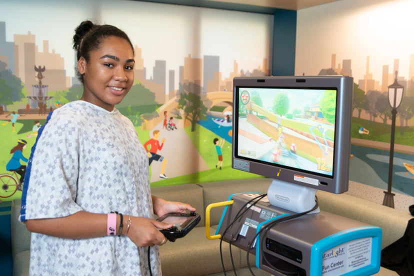 Girl in the hospital with a gaming station