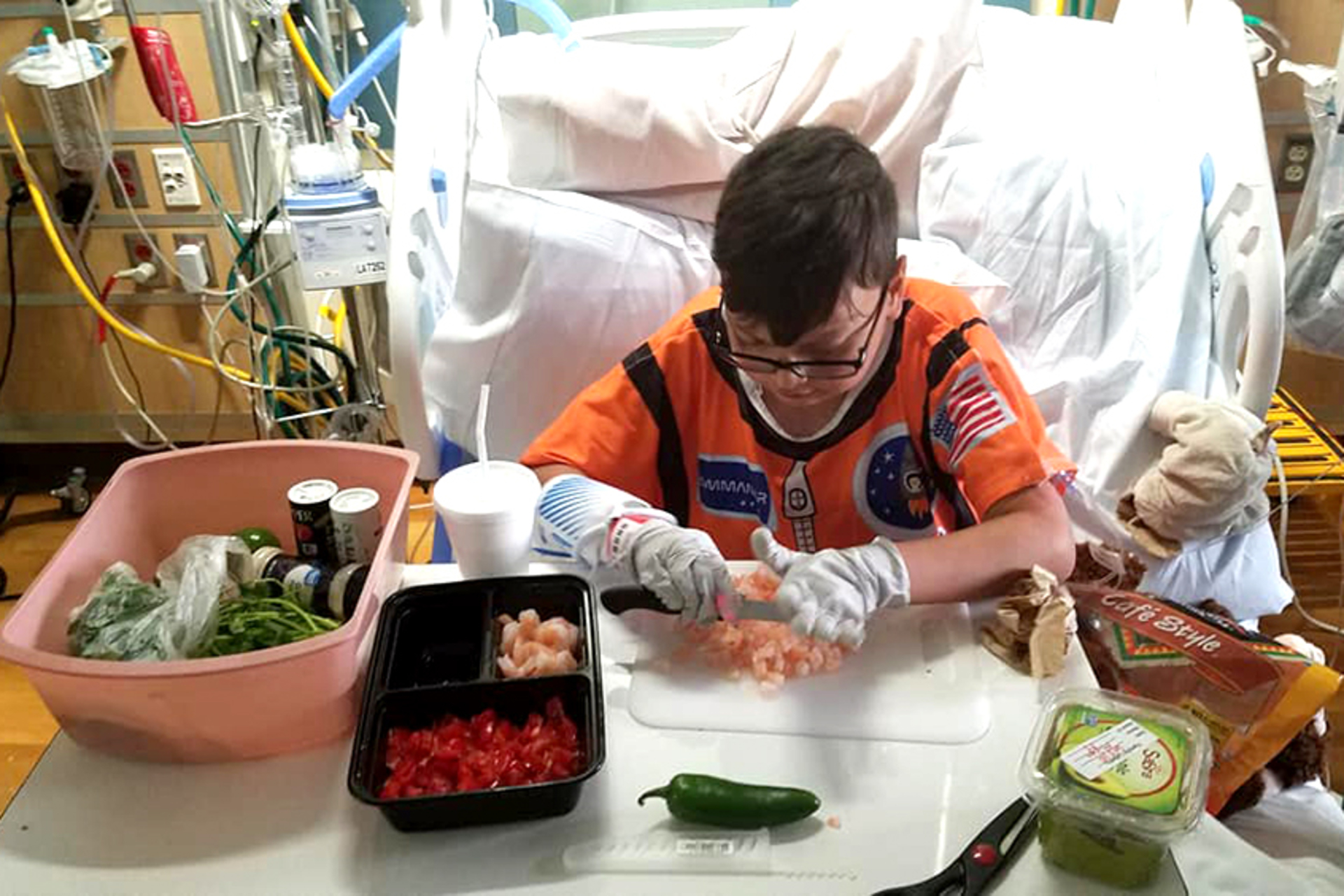 Juan, in his Starlight gown, cooking while in the hospital
