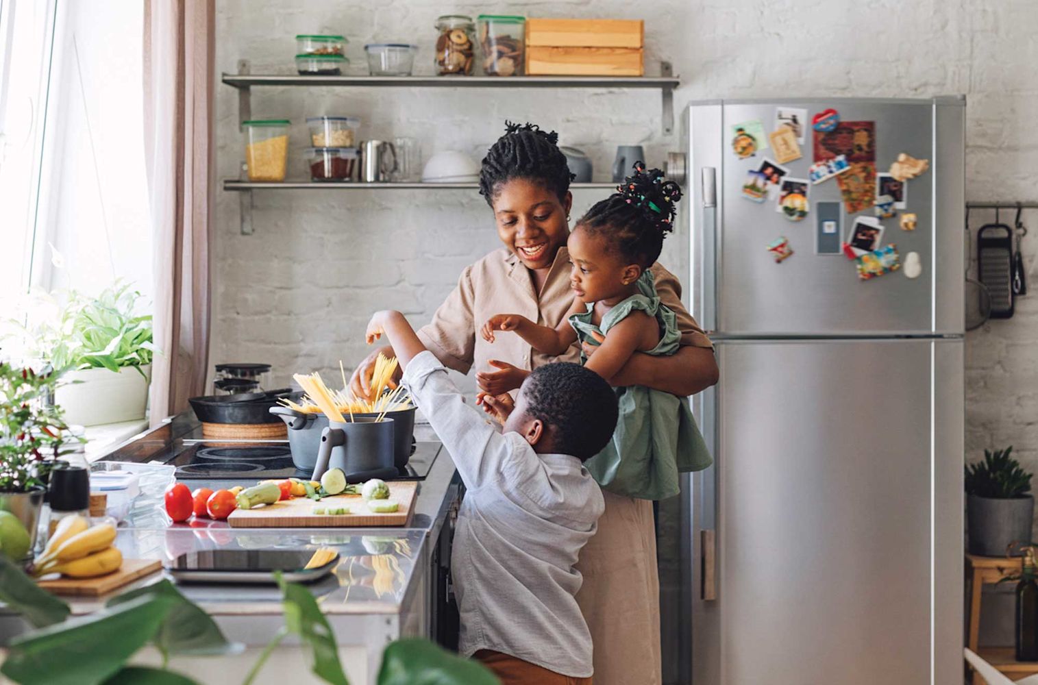 Mother enjoying her kitchen with her children in her new home from a mortgage loan from Financial Center Credit Union 