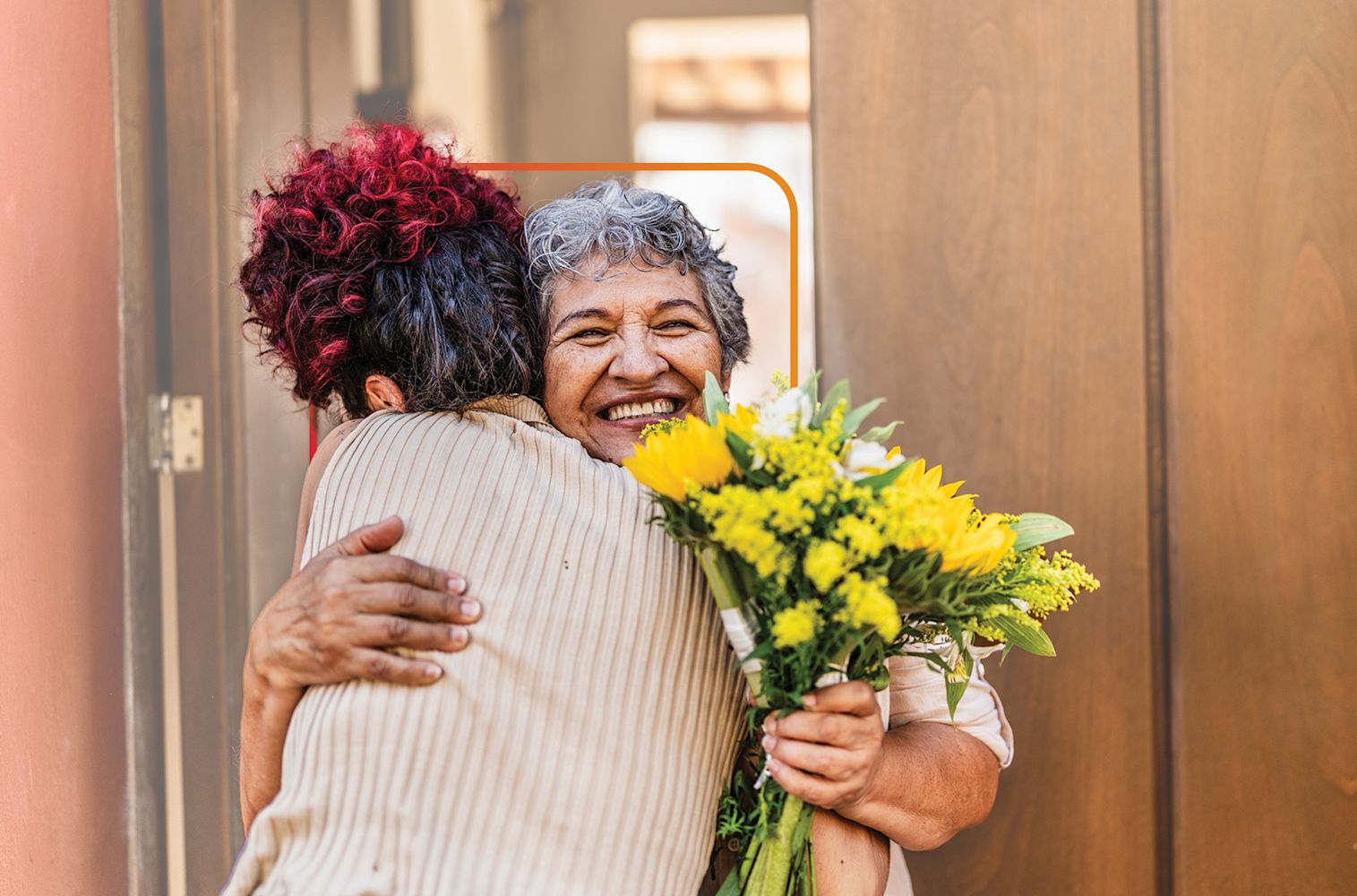 Friends hugging with flowers