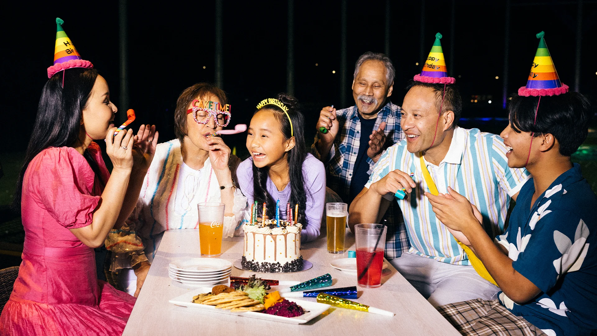 A group of people celebrating a birthday at a party hosted at Topgolf Gold Coast.