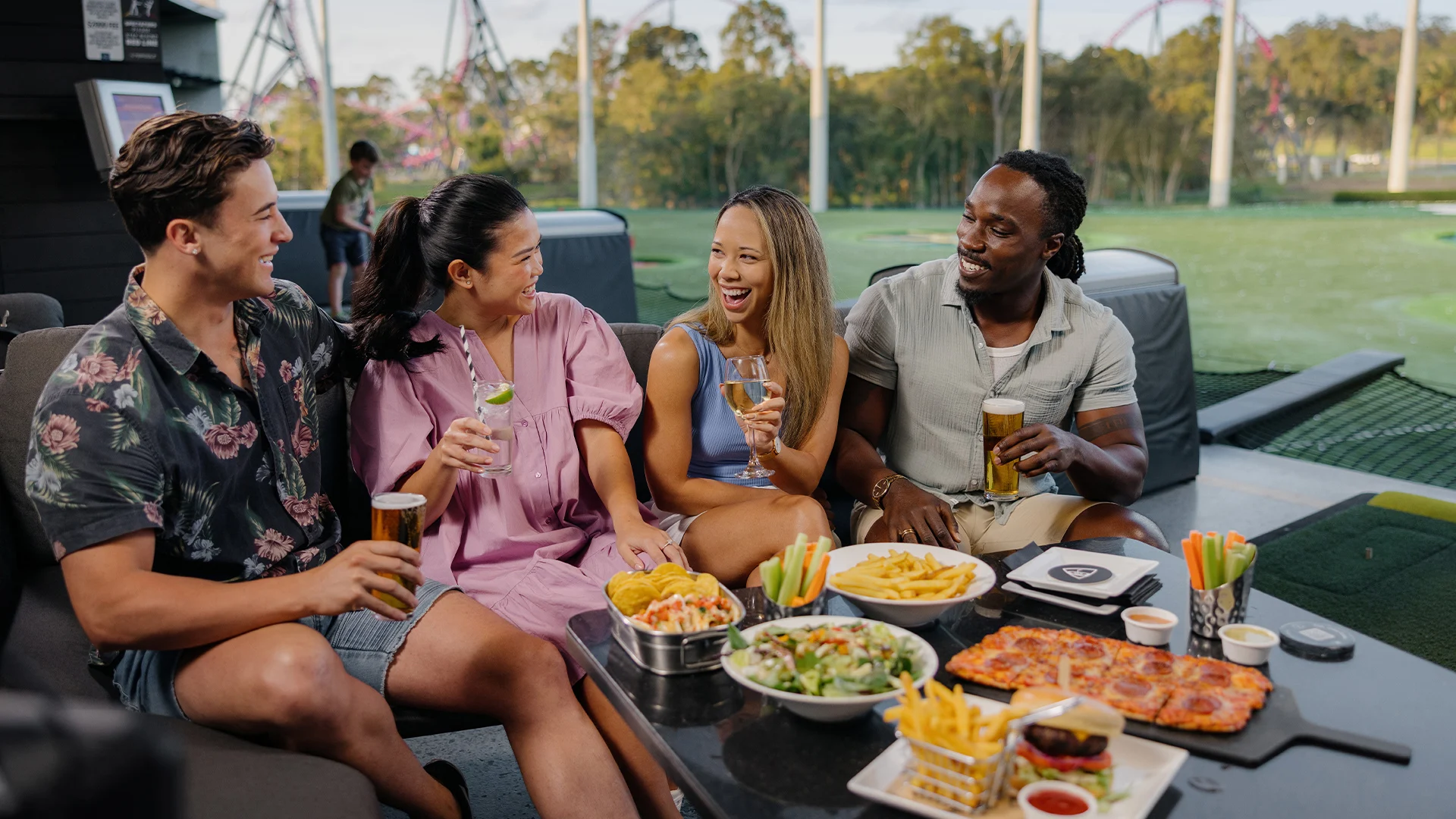 A group of people enjoying a meal at Topgolf Gold Coast.