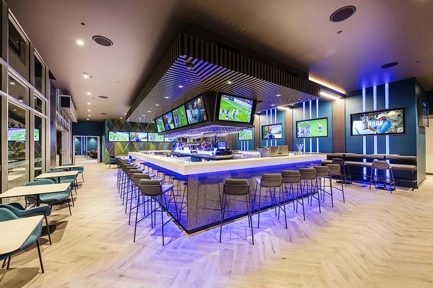 The Topgolf venue provides a lively and engaging atmosphere in its bar area, perfect for sports enthusiasts. Capture memorable moments with your friends and family, as the vibrant ambiance of the sports bar