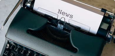 A typewriter with 'News' typed on a sheet