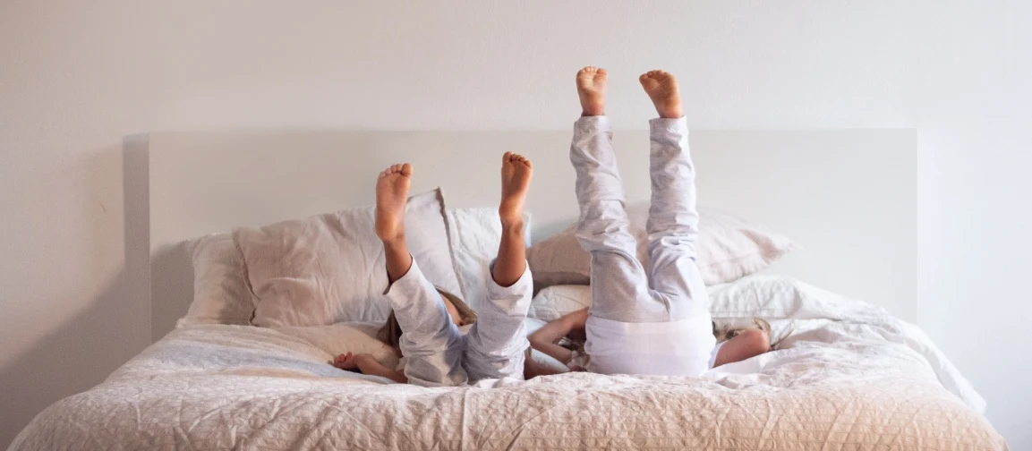 Two kids laying on the bed