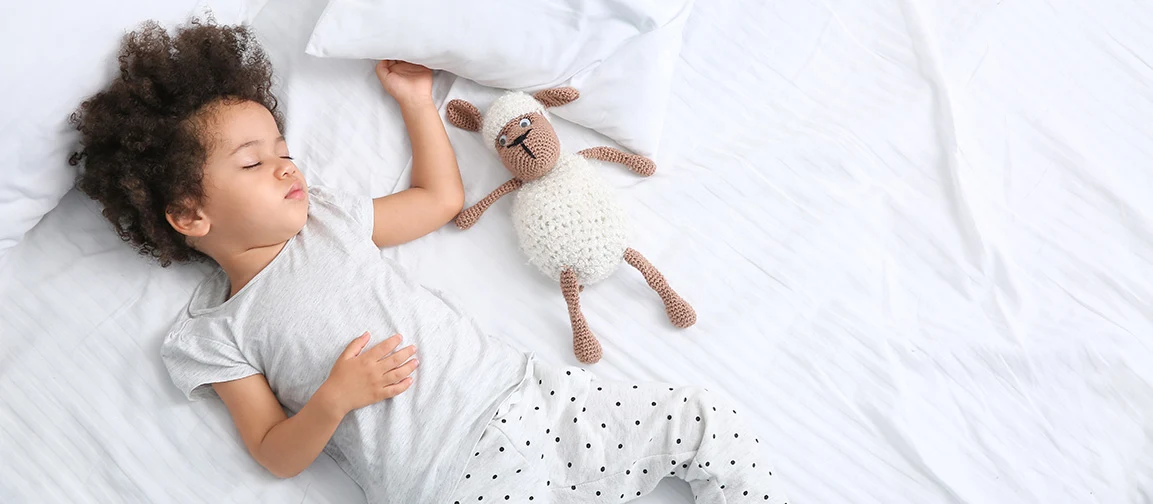 Kid sleeping on the bed