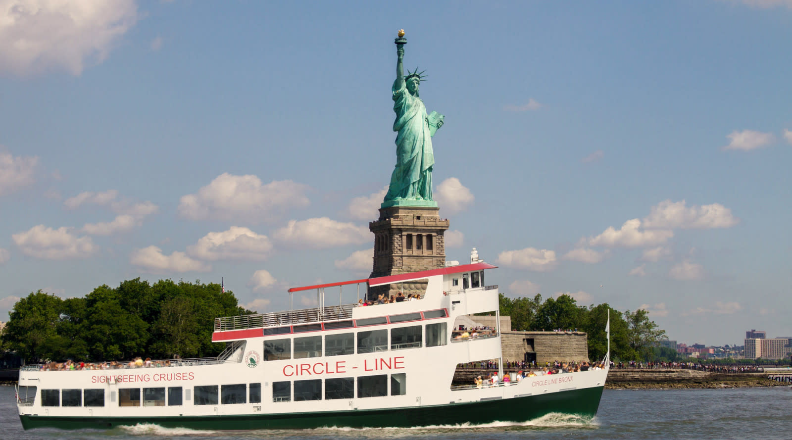 Circle Line boat in front of the Statue of Liberty