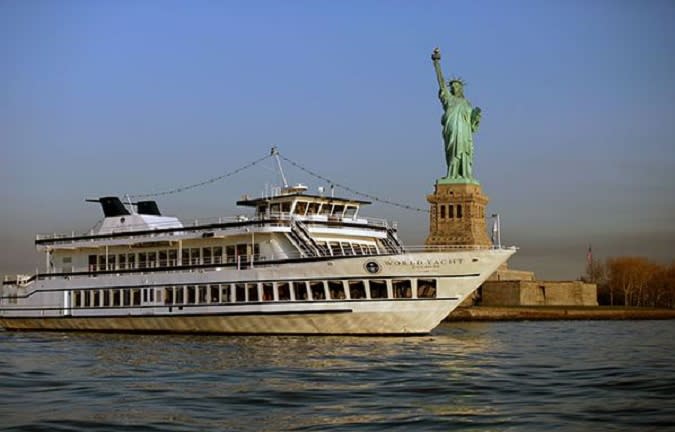 World Yacht next to the Statue of Liberty (1988)