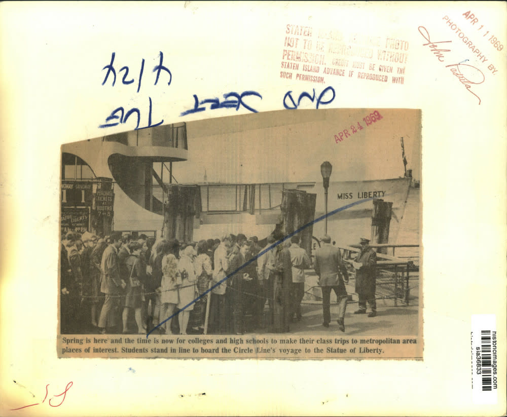 A group of students eagerly lined up to board the Circle Line ferry bound for the Statue of Liberty (1969)
