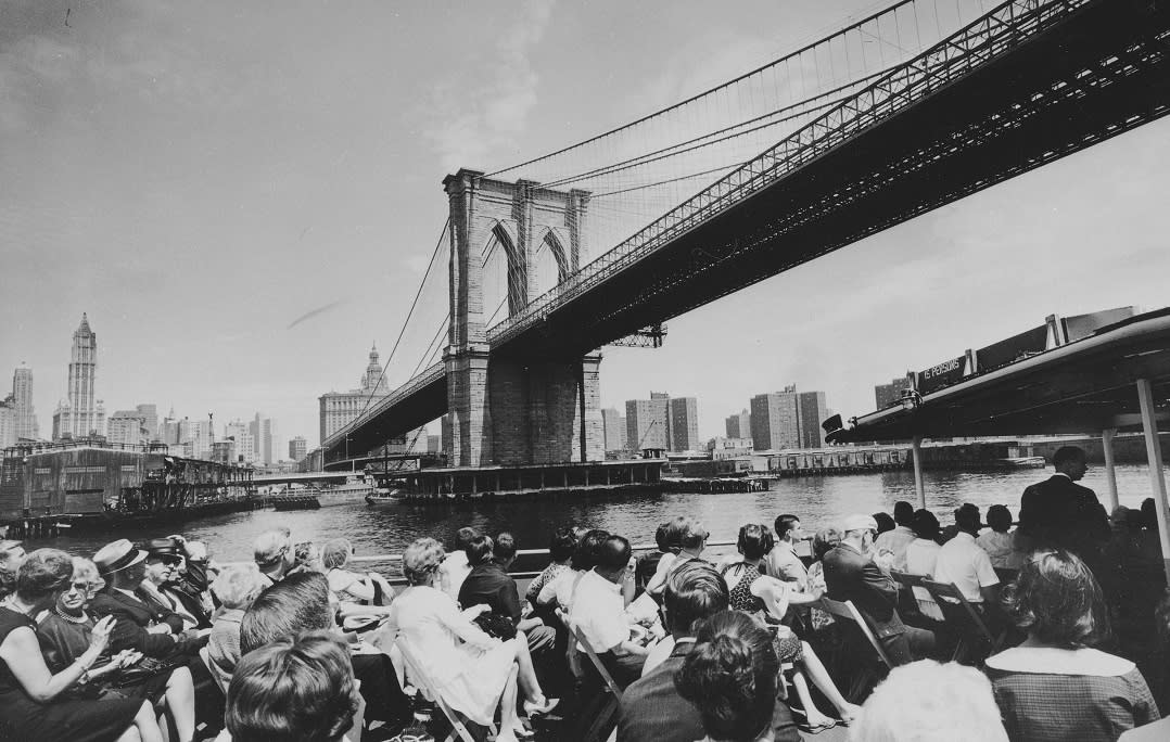 Historic image of Circle Line boat passing under the Brooklyn Bridge