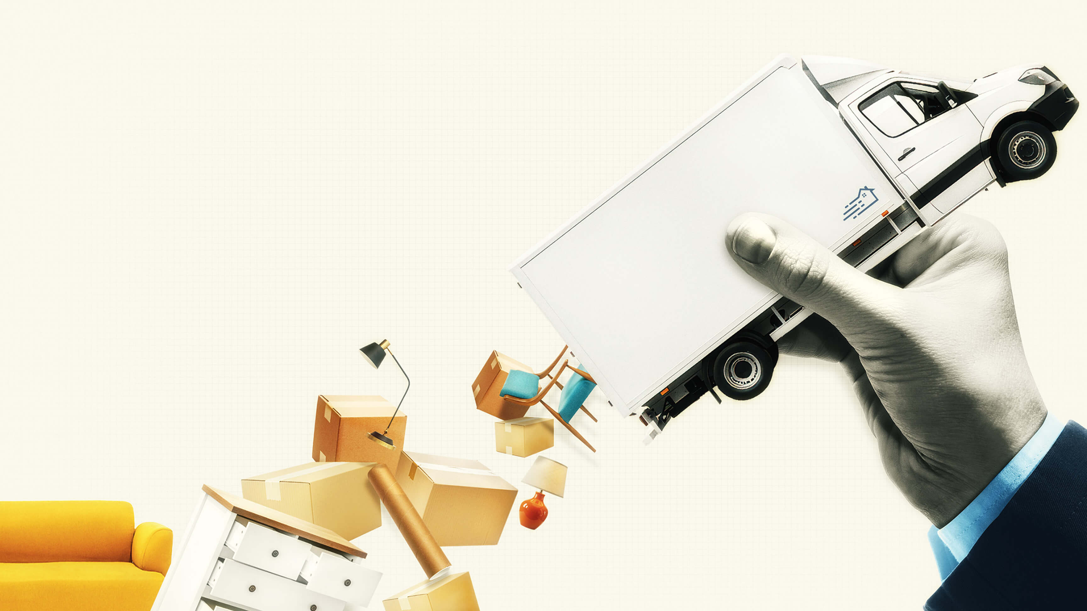 Conceptual image. A large hand in a business suit is holding a white box truck diagonally across the image, making the vehicle appear like a handheld object. Below the truck, various household items appear to be spilling out of the cargo area. These items include stacked cardboard moving boxes, a desk lamp, chairs, a dresser, a table, and decorative home accessories such as a vase and lampshade.