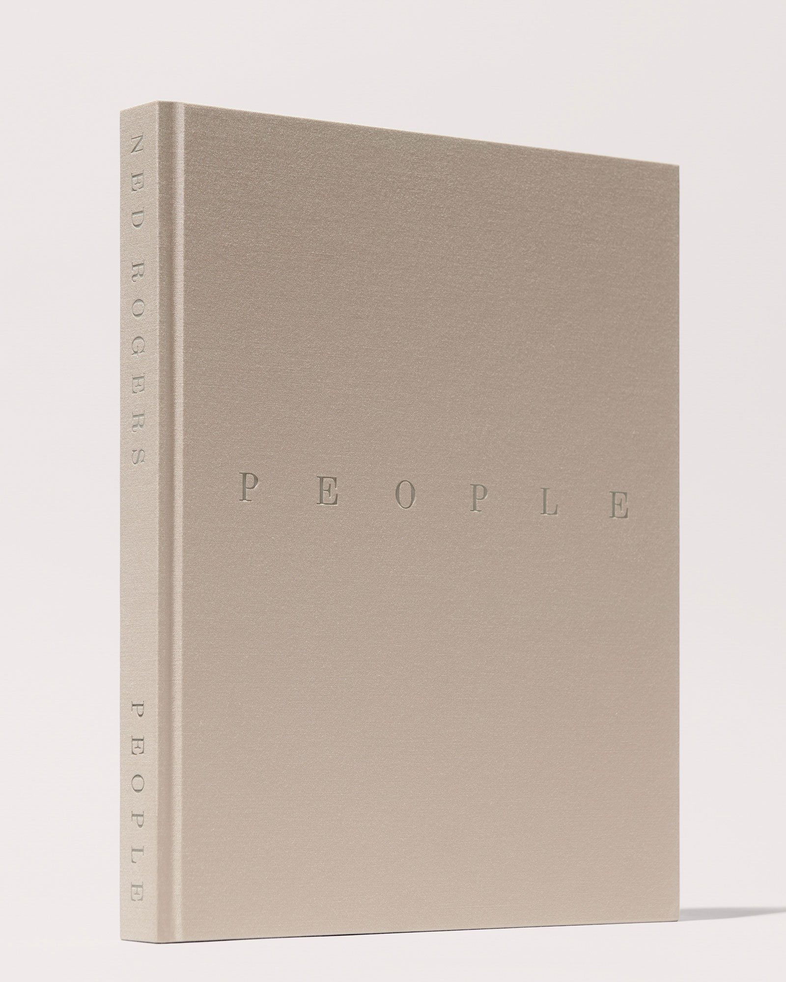 Cream colored hardcover book standing upright with the title "People" on the front. 