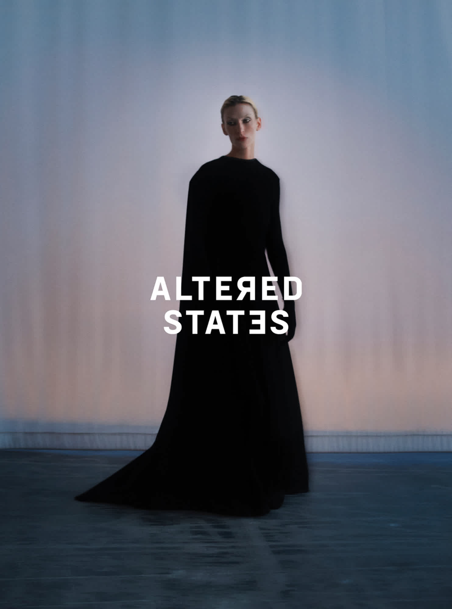 Woman in a floor length black dress is standing in the center of the frame. A dark blue to orange ombre is the background. ALTERED STATES is displayed in white text on the image.