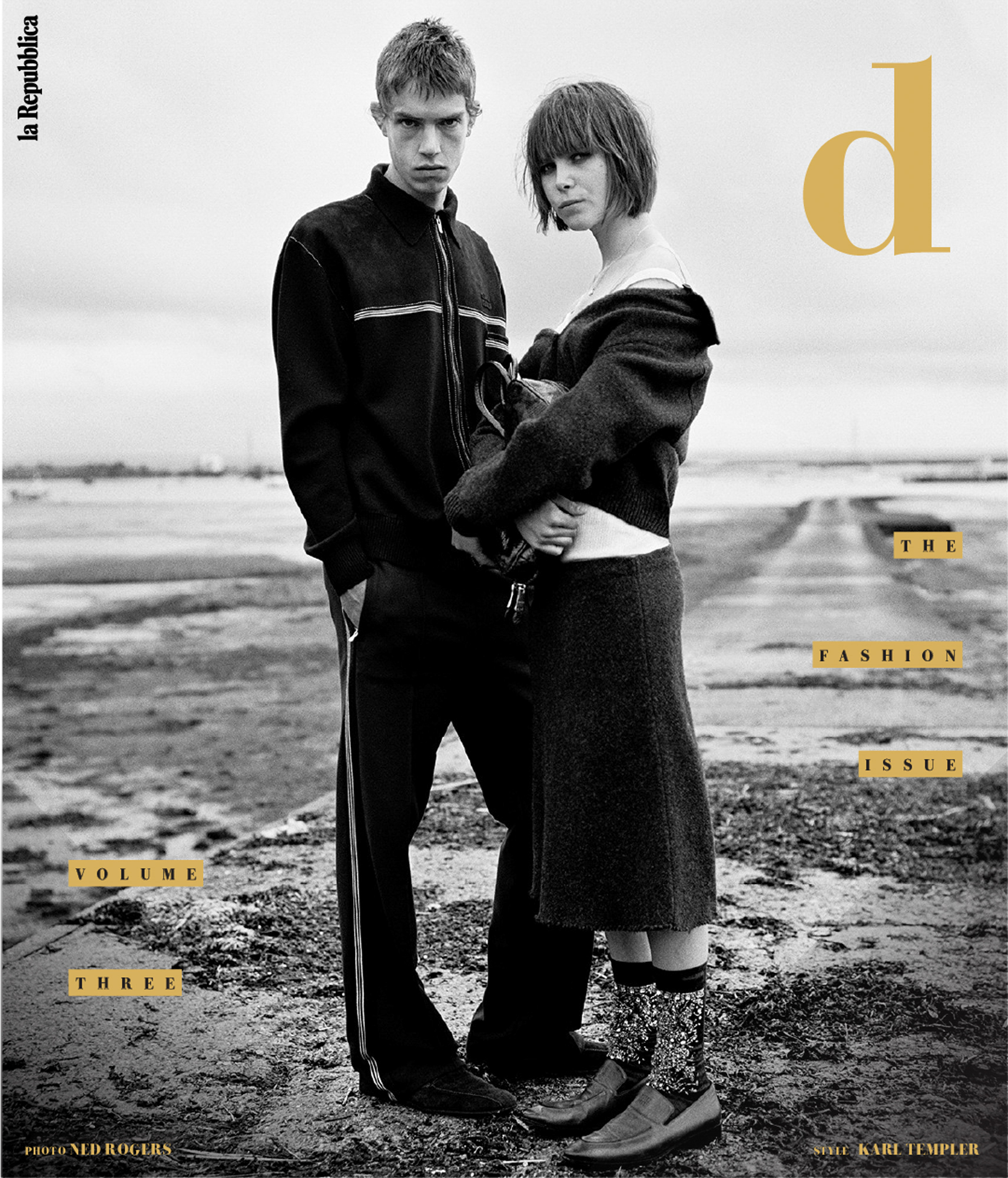 D Repubblica cover with gold text. The cover is a B&W image of a white man and woman standing close to one another on wet marsh land. 