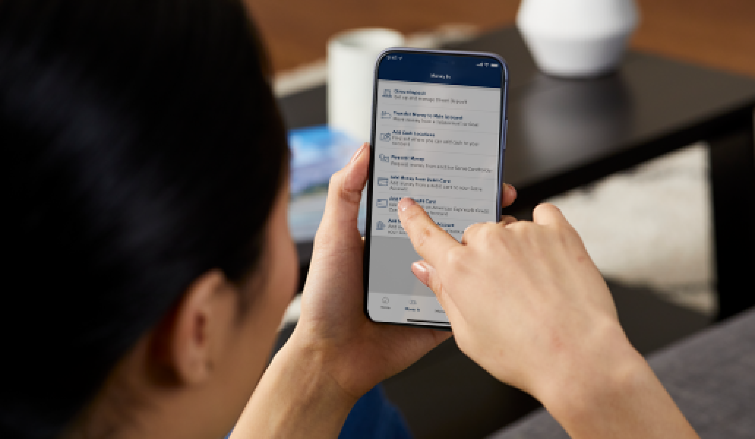 person holding a phone and tapping the screen