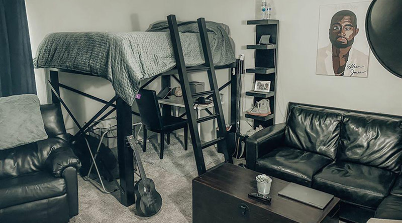 A black Queen Adult Loft Bed in a bachelor's apartment