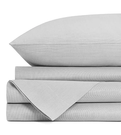 A partially visible and folded set of light gray sheets set against a white background.

