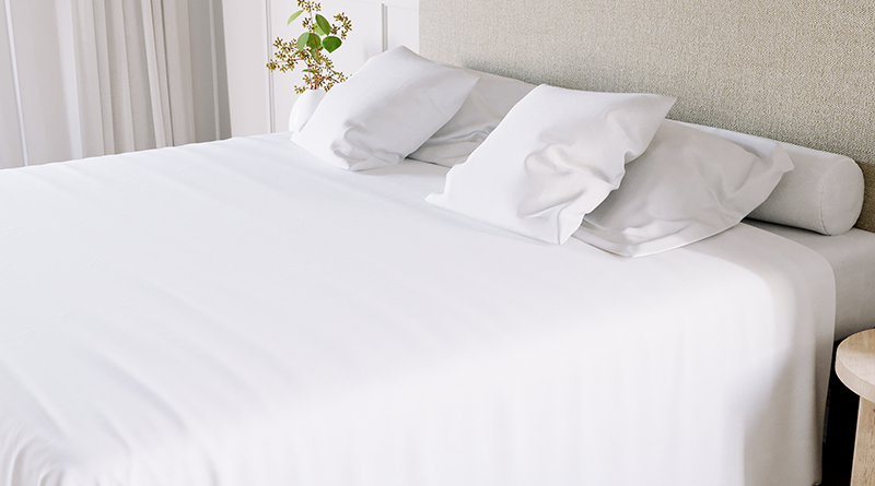 King size metal Platform Bed with a beige headboard and all white bedding covered in a white duvet with white pillow shams and pillowcases.