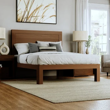 Light colored queen size wooden platform bed frame in a nice upscale room with light gray and white bedding seen from the lower right-hand corner of the bed.