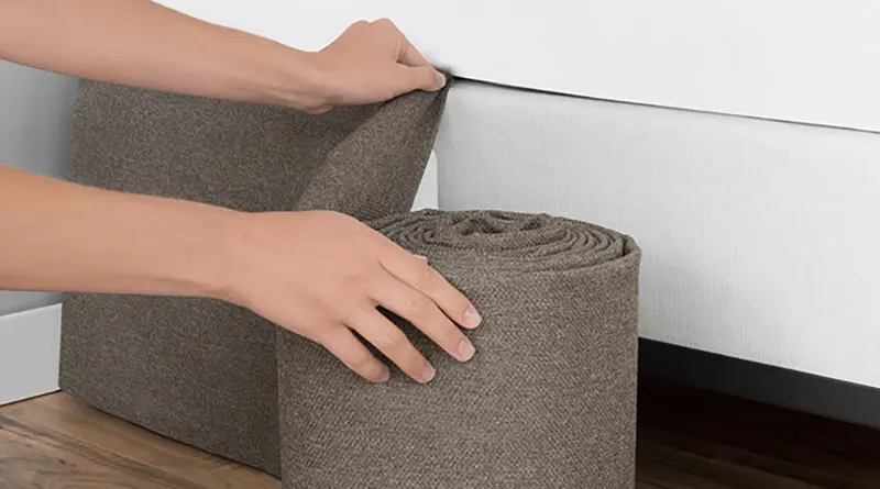 Close up shot of a brown Circa Bed Wrap being installed around a platform bed frame.