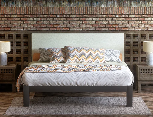 Charcoal Wyoming King size metal Platform Bed with a cream headboard in an upscale Western-themed hotel room. Seen directly from the foot of the bed.