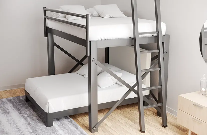 A Charcoal colored Queen Over Queen L-Shaped Bunk Bed for adults in a light, neutral, sparsely decorated room seen from a high angle on the lower right-hand corner of the top bunk.