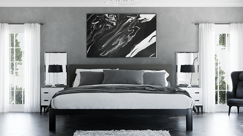 Black Alaskan King Bed in a high-end luxury bedroom with mostly gray and black and white decor seen directly from the foot of the bed.