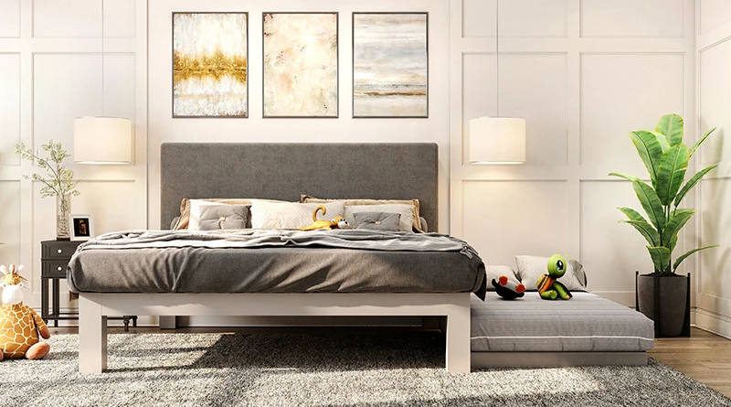 A light gray king size Platform Bed with a trundle extended out from under the bed frame.