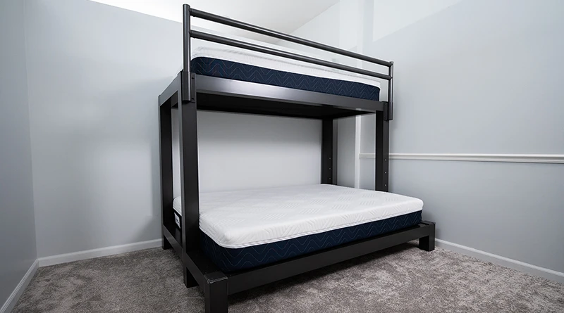 A charcoal Twin XL Over Queen Adult Bunk Bed with two undressed Francis Lofts & Bunks mattresses on each bunk.
