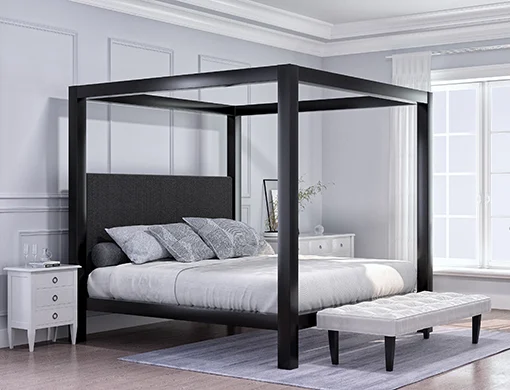 A charcoal Wyoming King size Canopy Bed in a light, sparsely decorated but upscale bedroom. Seen directly from the lower right hand corner of the bed.