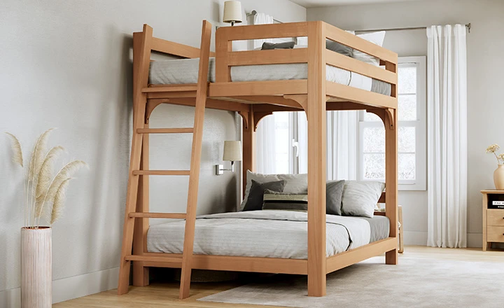 A light colored queen over queen Wood Bunk Bed for Adults in an upscale, airy guest bedroom seen from the foot of the bed frame where the ladder rests at a slight angle toward the left-hand corner of the bed.