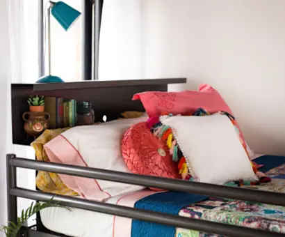 Close up on a top bunk bookshelf on a charcoal Queen Over Queen Adult Bunk Bed