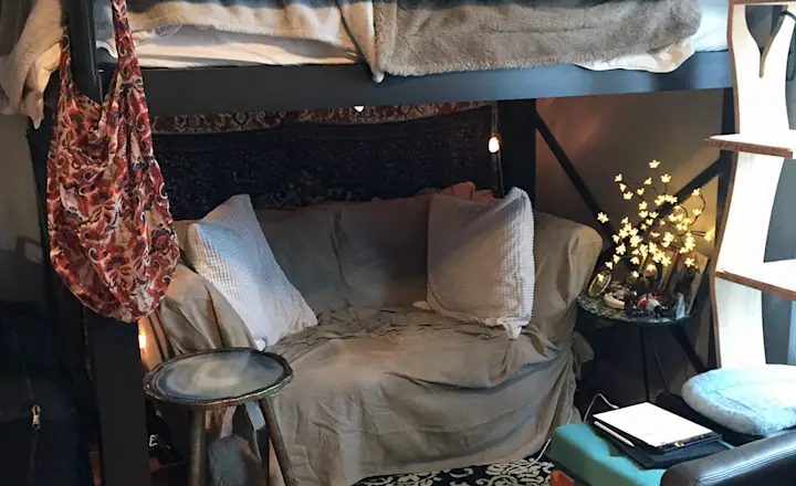 A charcoal Full XL Adult Loft Bed in the bedroom of a young adult woman with a love seat beneath the bed