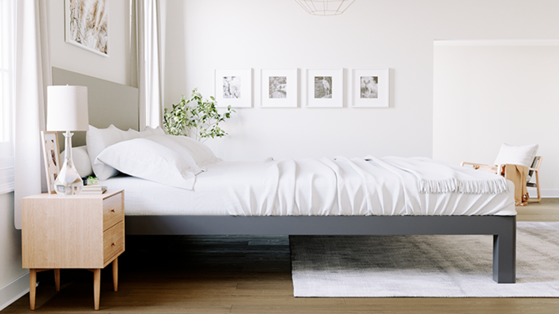 Charcoal Alaskan King Bed with a light gray headboard in a nice, neutral master bedroom seen directly from the right-hand side of the bed frame.