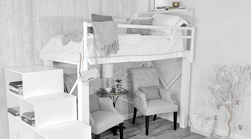 A beautiful white Adult Loft Bed with two grey chairs beneath the bed frame seen from a corner angle