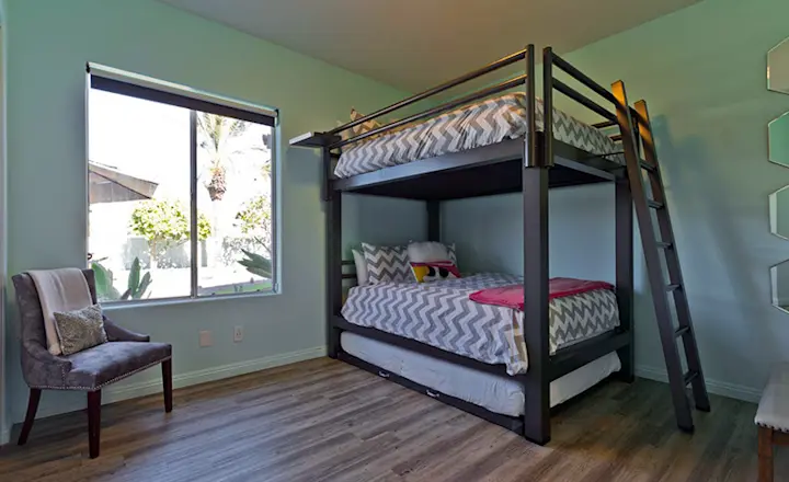 A Charcoal Queen Over Queen Adult Bunk Bed with trundle accessory in a Coachella Valley vacation rental