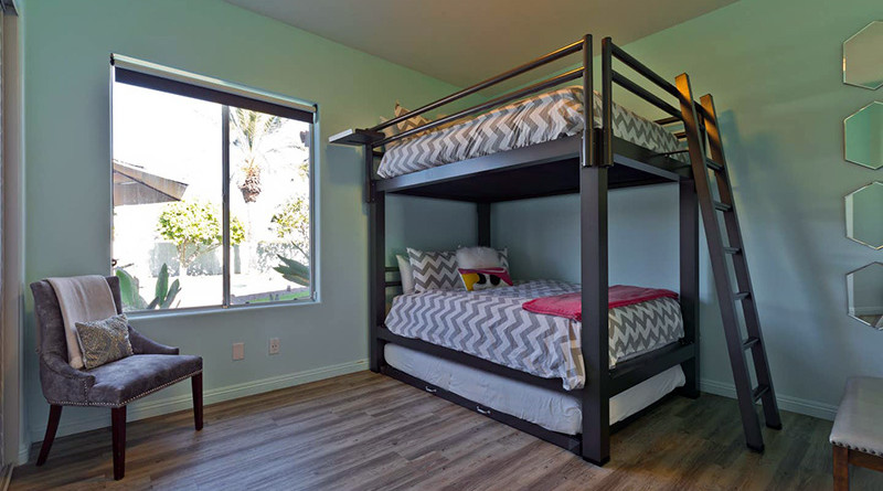 A Charcoal Queen Over Queen Adult Bunk Bed with trundle accessory in a Coachella Valley vacation rental