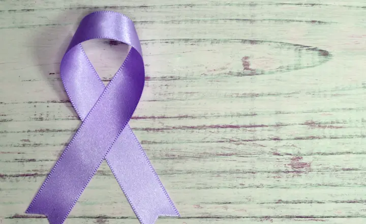 A purple ribbon representing domestic violence awareness.